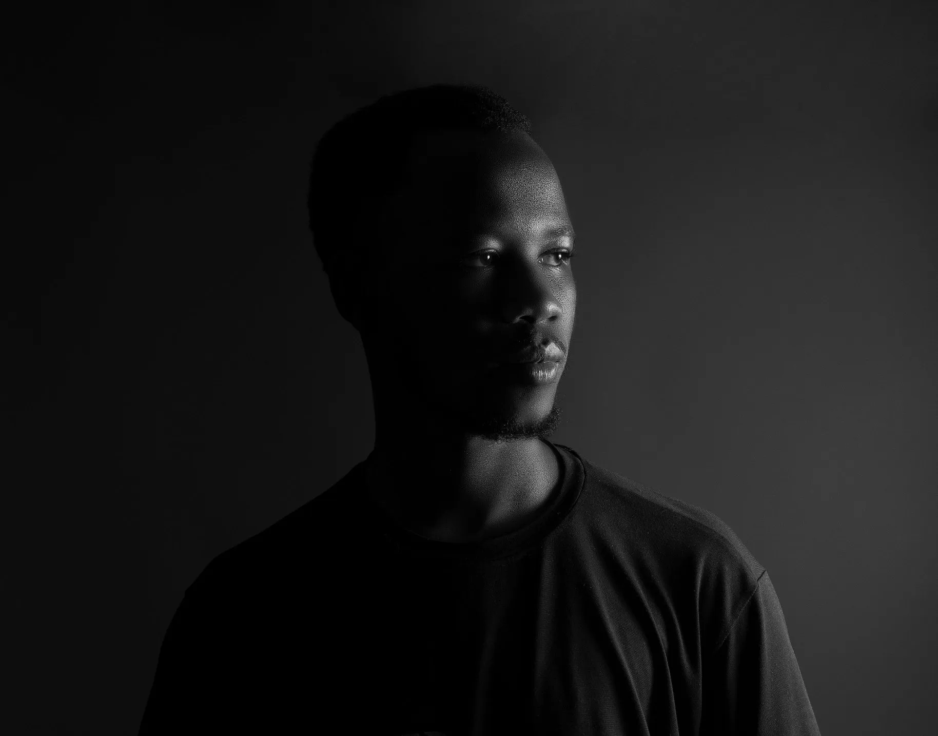 Apparel: drop 01, a monochrome portrait in a dark tee